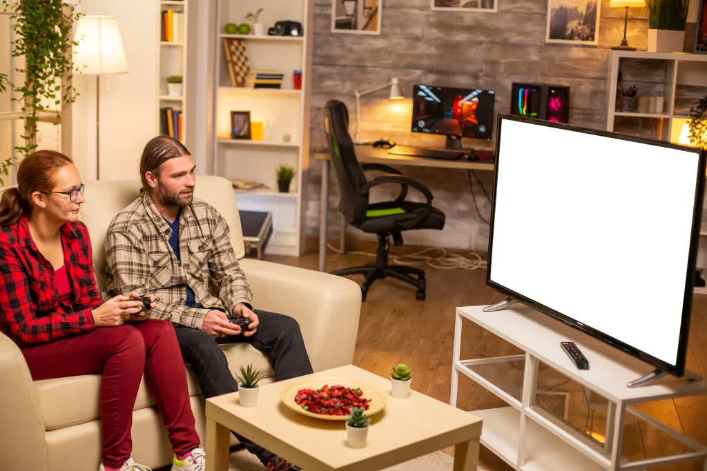 couple playing video games isolated white tv screen late night living room